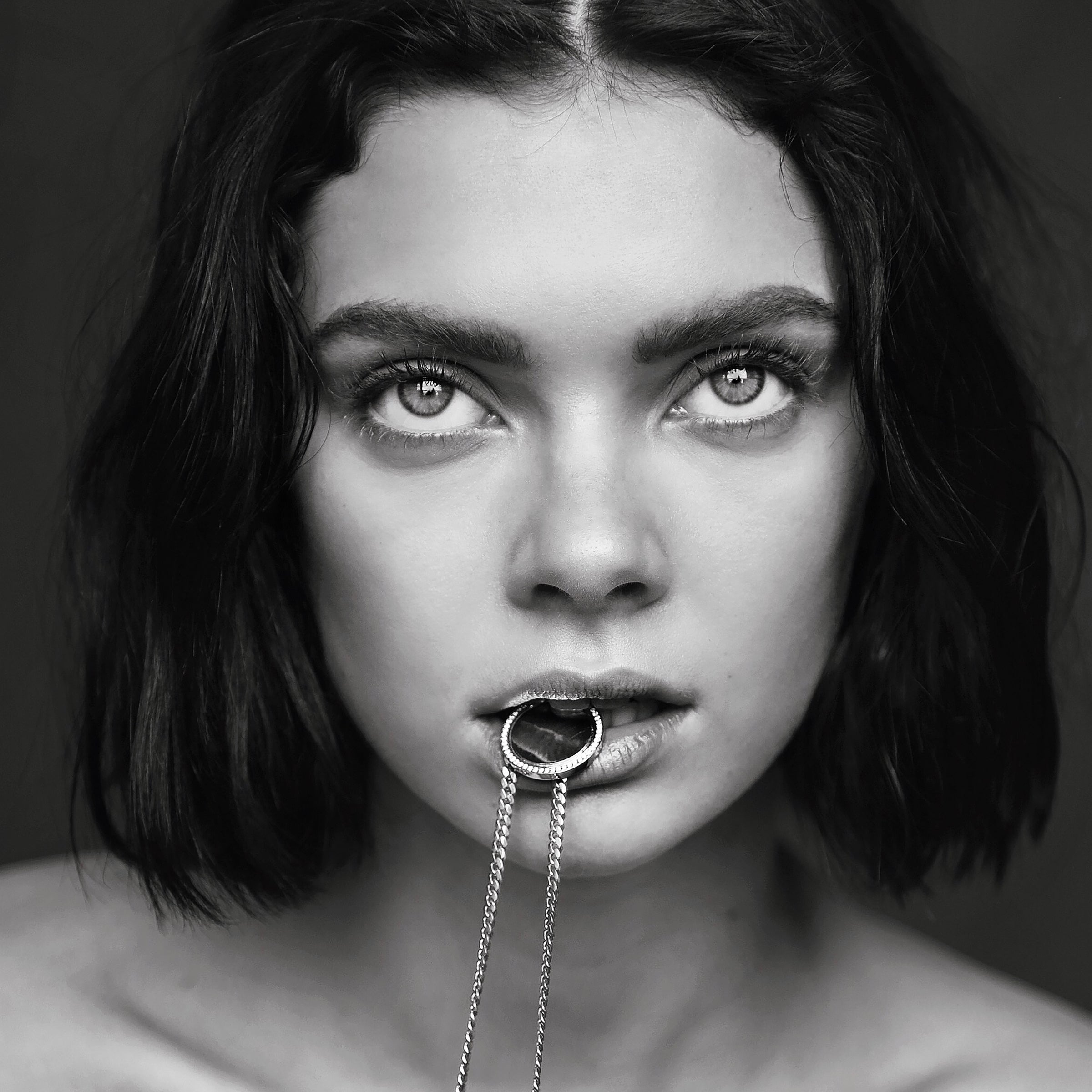 Woman holding the Vatican Coin Pendant in her mouth